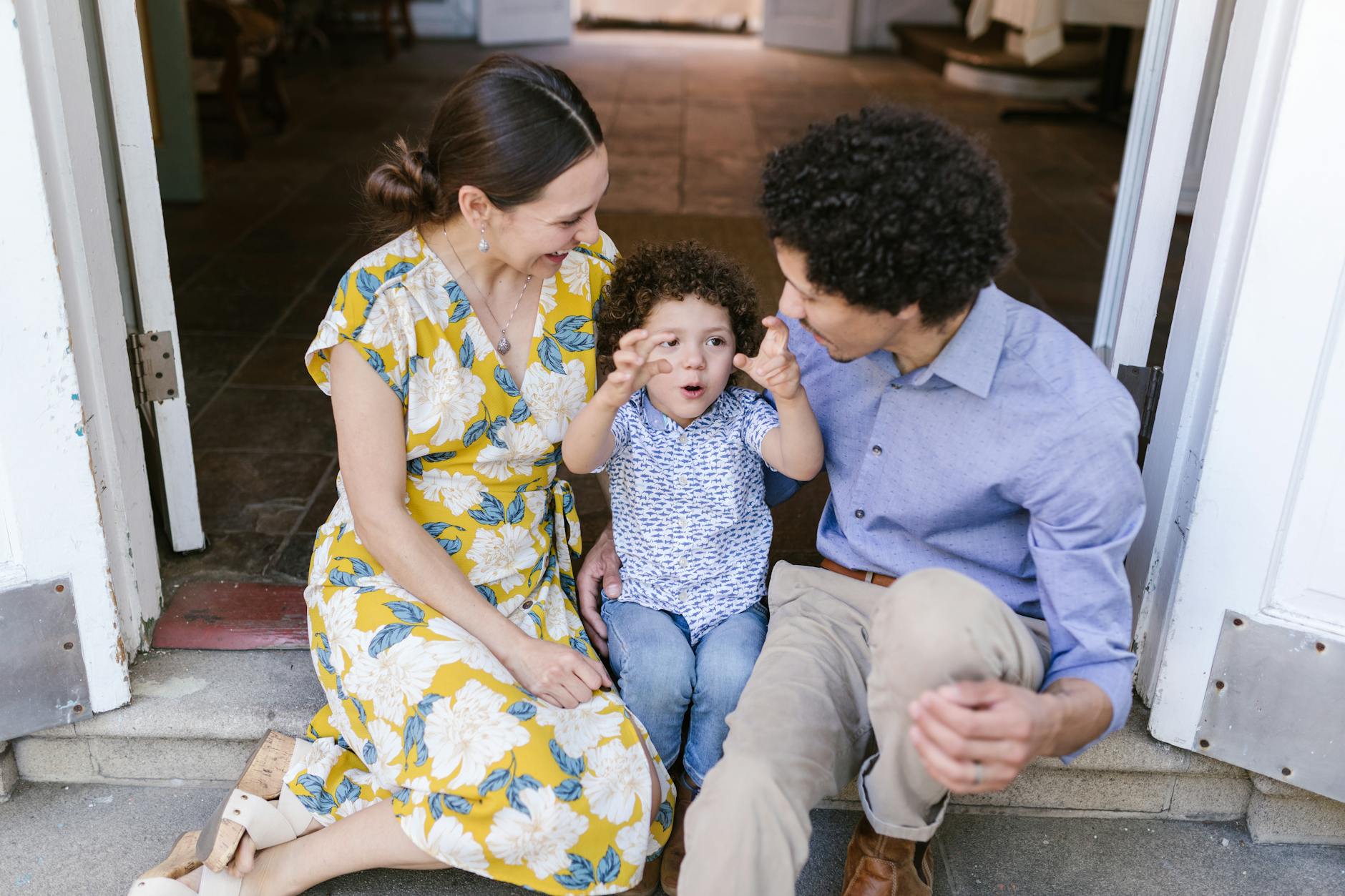 little boy telling his parents his adventures sitting on the doorstep