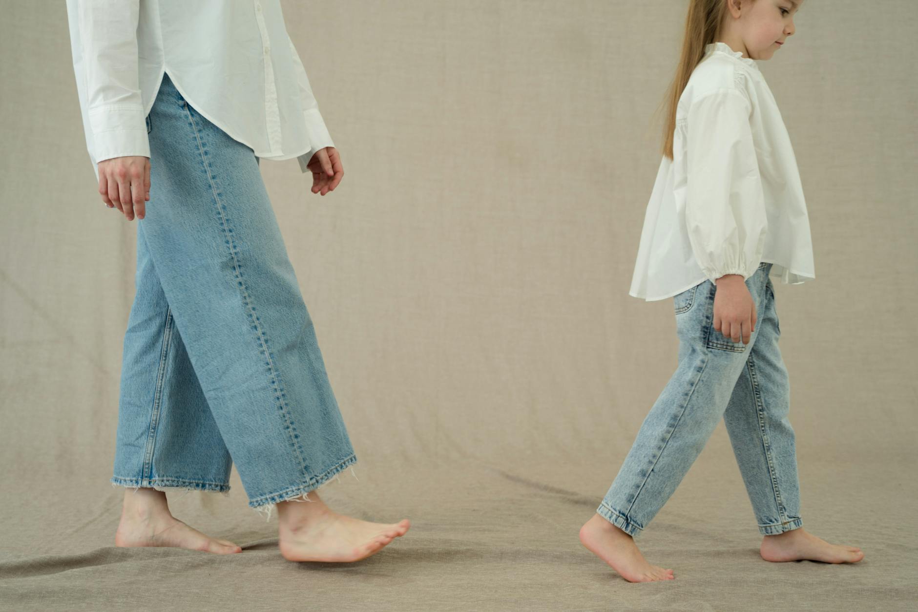 a mother and her daughter wearing denim pants